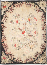 Large early–mid 20th century American hooked rug (8’8” x 11’10”) with a soft ivory floral field in muted pastels, framed by a bold charcoal border with red and cream scrolling vines; from a New Hampshire collection.