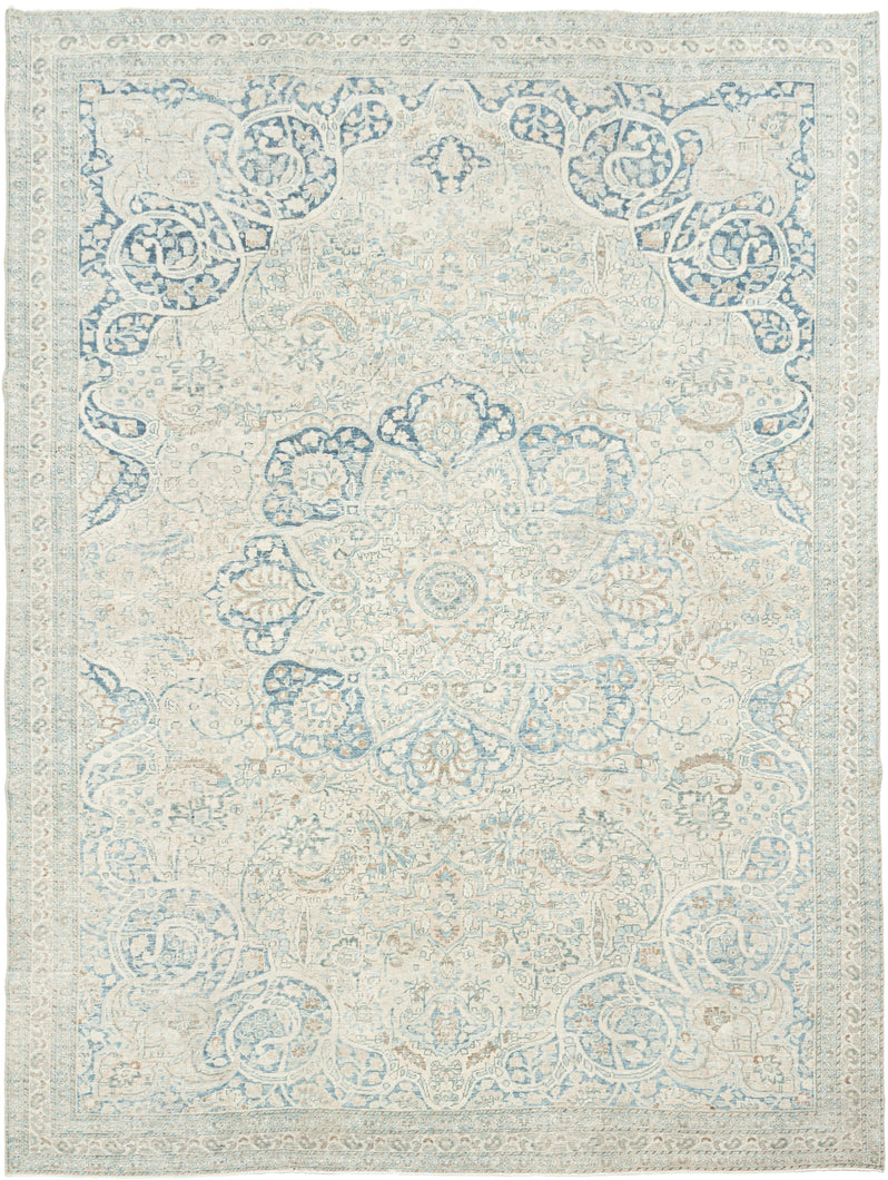 It features an elegant central medallion surrounded by flowing arabesques and floral tracery in delicate shades of sky blue, ivory, and soft taupe. The pale, airy palette and finely drawn design lend the piece a refined, almost ethereal quality that makes it versatile for both traditional and contemporary interiors. Framed by a scrolling vine border, this rug is a study in subtle sophistication and is a timeless decorative element for any space.