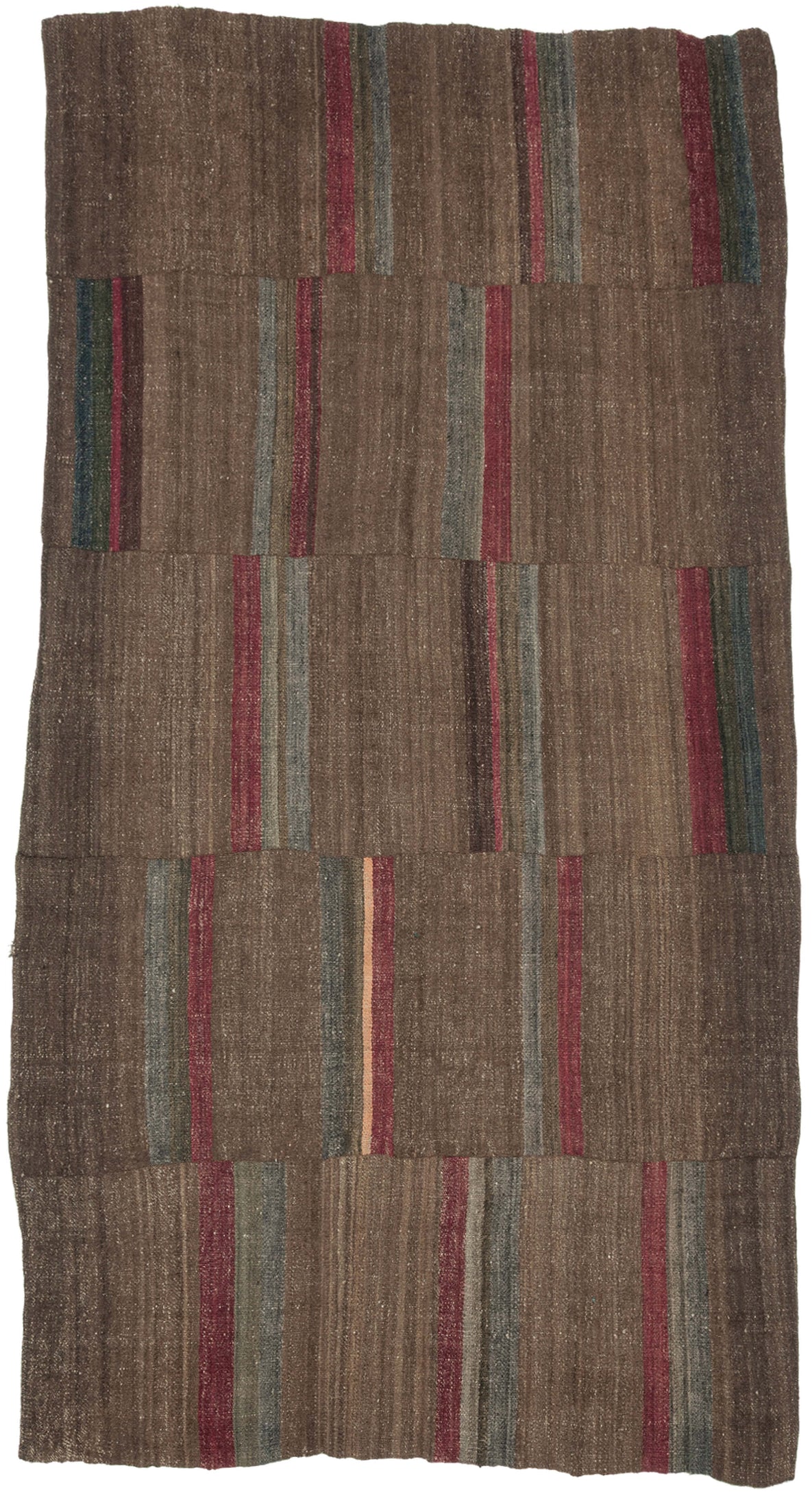 An early 20th century Dolpo blanket woven from handspun wool in the high Himalayan region of northwestern Nepal. Constructed from joined panels, the surface carries a quiet patchwork rhythm created by subtle shifts in tone and the intentional rotation of narrow striped bands.