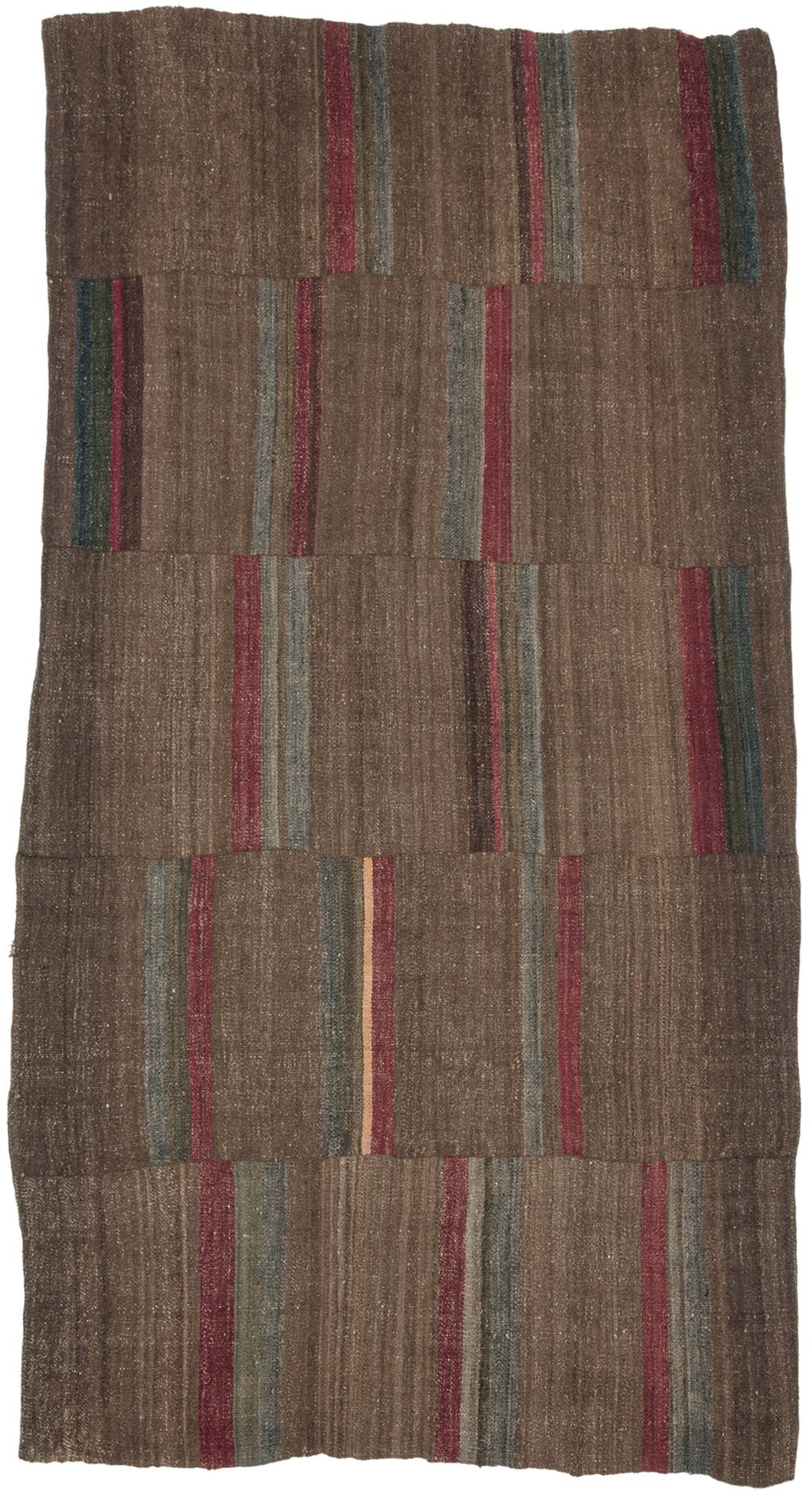 An early 20th century Dolpo blanket woven from handspun wool in the high Himalayan region of northwestern Nepal. Constructed from joined panels, the surface carries a quiet patchwork rhythm created by subtle shifts in tone and the intentional rotation of narrow striped bands.