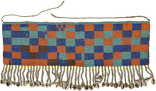A vibrant beaded cache-sexe from Cameroon, composed of dense glass beadwork in bold blocks of orange, cobalt blue, turquoise, and brown. The lower edge is finished with&nbsp; cowrie shells.