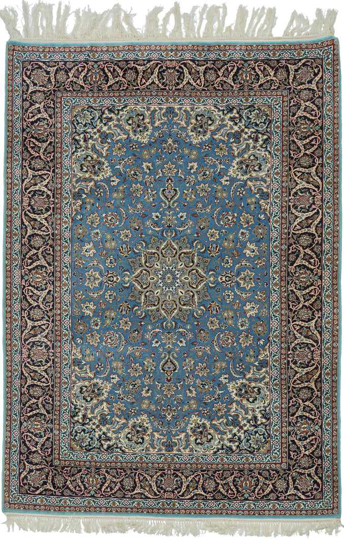 This elegant vintage Nain rug showcases the refined floral artistry that has made these weavings among the most admired of workshop carpet traditions. A luminous sky-blue field is centered by an intricate ivory and camel medallion, surrounded by a graceful lattice of scrolling arabesques, delicate blossoms, and finely drawn palmettes. The richly contrasting midnight navy border frames the composition beautifully, adding depth and sophistication.