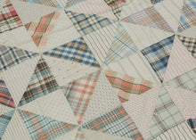 This vintage patchwork quilt was crafted in North America during the middle of the 20th century.


It features patch-worked grid composed of squares. Each square is formed of well balanced triangles of either colorful flannel patterns or more open dotted and striped cream ground patterning. The squares have been pieced together wondefully and the composition can be read many different ways that is accentuated by its perfectly square dimensions.