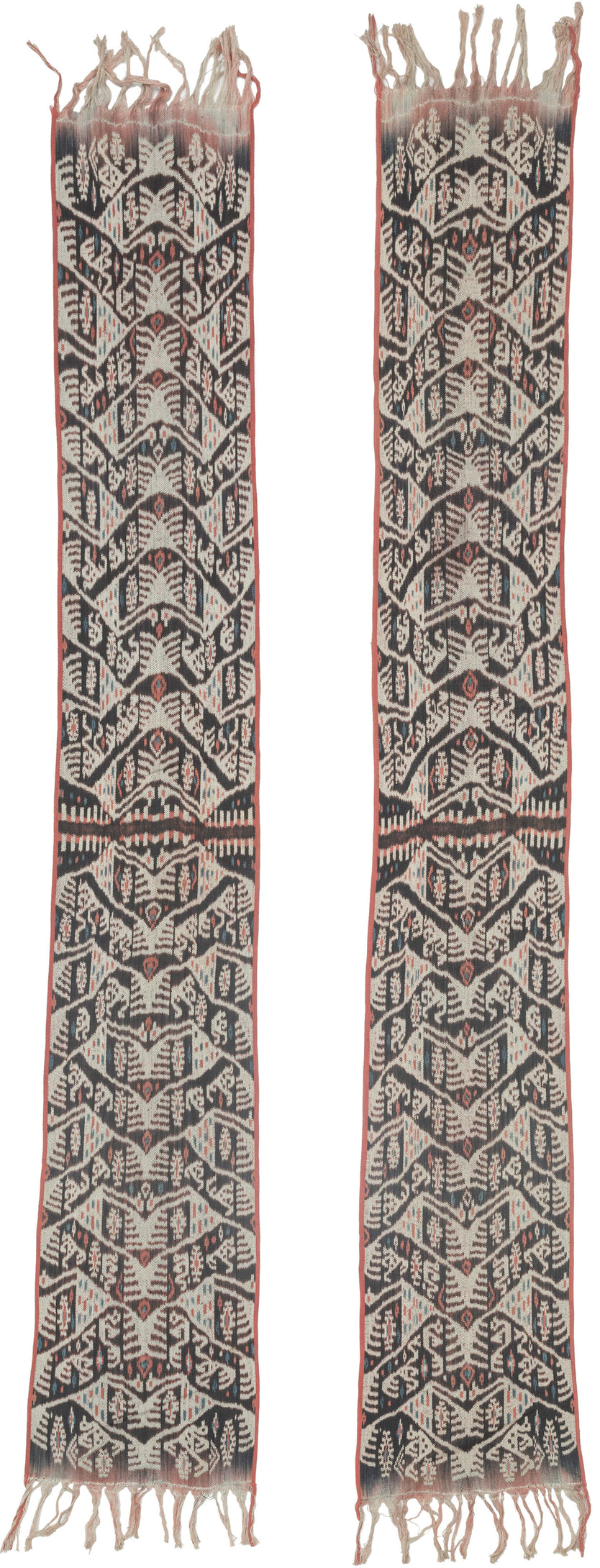 A striking West Timor cotton ikat featuring rhythmic ancestral and vegetal motifs arranged in a vertical progression. Deep brown-black and soft ivory form the primary contrast, accented by subtle coral and indigo details that animate the surface.

The repeating abstracted figural forms and branching motifs reflect Timorese ceremonial weaving traditions, executed in warp ikat with characteristic feathered edges. Finished with traditional fringe and side bindings.