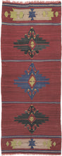 Anatolian kilim that features a simple yet striking composition. The kilim is borderless and broken into five horizontal sections separated by thin blue and tan stripes on a dramatic dark raspberry field. The top and bottom sections are composed of matching cartouche like devices in chartruese, tan and periwinkle. The inner panels feature three graphic hooked medallions; the central periwinkle medallion flanked by two darker black medallions.