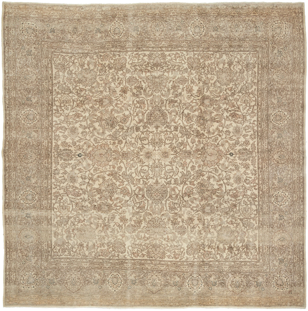 A softly washed-out mid-century Sivas rug handwoven in central Anatolia, featuring an even, atmospheric palette and a finely detailed floral field. The original drawing remains legible yet subdued, creating a gentle, almost parchment-like surface where pattern and ground merge into a cohesive whole. Subtle animal figures are interwoven within the scrolling arabesques, revealing themselves gradually and rewarding closer looking.