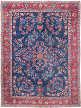 An elegant vintage Tabriz carpet distinguished by its unusually deep indigo-blue field and spacious floral drawing. A softly articulated central medallion anchors the composition, surrounded by scrolling vines, palmettes, blossoms and delicate boteh rendered in saturated shades of cornflower and sky blue, rose, coral, red, celadon, camel and ivory.