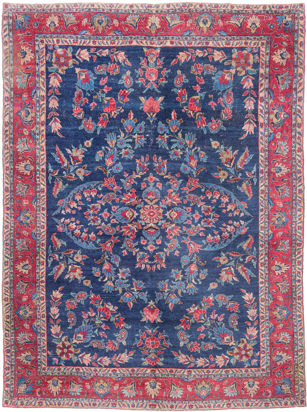 An elegant vintage Tabriz carpet distinguished by its unusually deep indigo-blue field and spacious floral drawing. A softly articulated central medallion anchors the composition, surrounded by scrolling vines, palmettes, blossoms and delicate boteh rendered in saturated shades of cornflower and sky blue, rose, coral, red, celadon, camel and ivory.