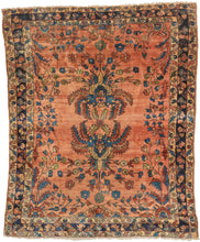 This cheerful Lilihan is distinguished by an especially striking mirrored bouquet motif, in which scrolling vines grow from two central bouquets, each adorned with large, hanging serrated leaves. Set against a warm coral field, the design feels both formal and expressive, with the unusual mirrored botanical elements radiating outward in a balanced, confident arrangement.