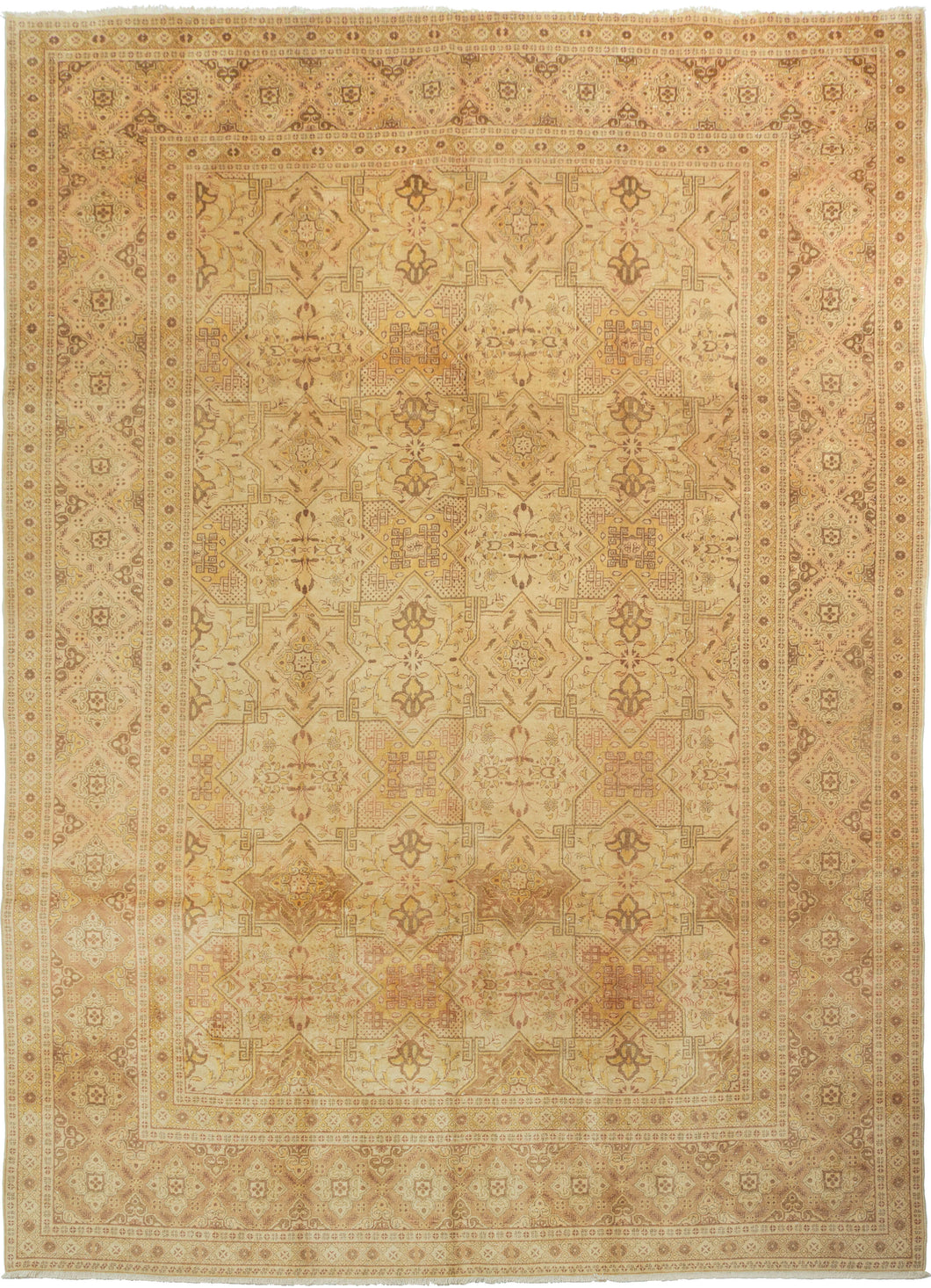 An elegant mid-20th-century Tabriz carpet distinguished by its intricate allover design and softly washed palette.

The field is organized as a continuous lattice of interlocking angular compartments, alternating with floral medallions, palmettes and smaller geometric devices. The tightly fitted shapes create an almost tessellated rhythm across the surface, balancing strong architectural structure with delicate vegetal drawing.