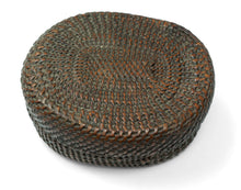 A finely made lidded basket attributed to the Kuba peoples of the Democratic Republic of the Congo, tightly plaited from plant fiber into a compact, low rounded form.

The weaving radiates outward from the center in subtly shifting directions, creating a quiet sense of movement across the otherwise unadorned surface. The closely fitted lid and shallow base reflect the technical precision for which Kuba basketry is known.