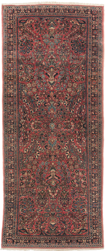 This rug showcases a classic curvilinear floral design on a deep red field beautifully detailed with scrolling vines, palmettes, and blossoming sprays. This classically patterned rug is perfect for high traffic areas and should last for generations to come. It's rare short runner size makes it perfect for an entryway, kitchen or as a statement piece in a more intimate space.