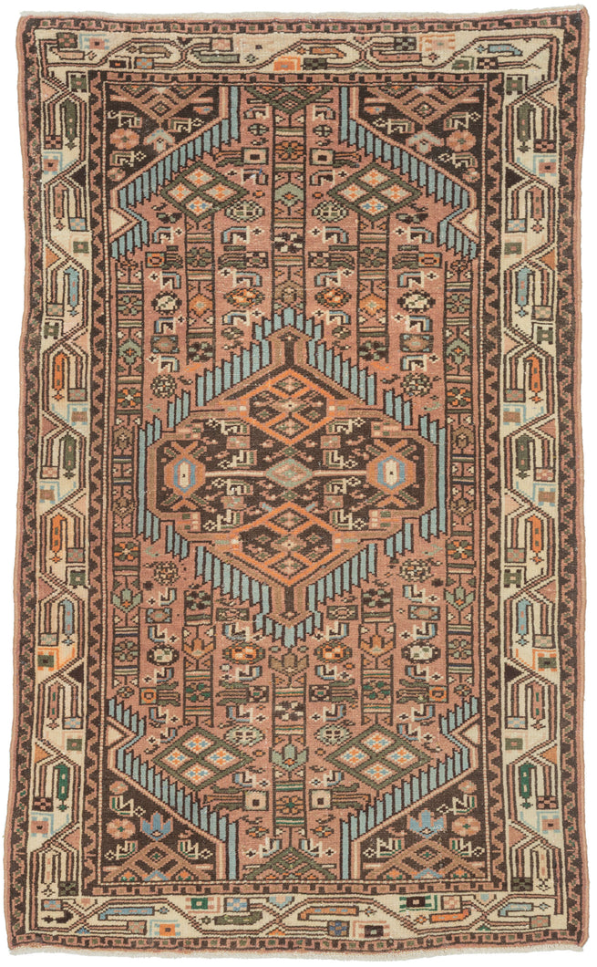 A lively small Hamadan with a geometric medallion composition set against a warm rose-brown field. Crisp ivory, turquoise, deep brown, and soft orange accents create strong contrast and rhythmic movement across the surface.