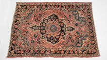 It features of an deep navy central medallion on a crimson ground. The field is filled with fine floral sprays and balanced by four scalloped cornices woven in light blue. The border is composed of a straightforward floral meander in the same deep navy almost black ground of the central medallion. SAROUK PAIR