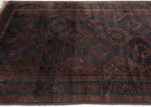  Timuri Baluch was handwoven during the second quarter of the 20th century in Western Afghanistan.

It features a lattice pattern of stepped diamonds and serrated polygons. With lush deep blue and red wool with a dark but lustrous complexion. The addition of a dark brown which has oxidized naturally sculpts the pattern and gives the shapes the feeling of floating in space. Bright speckles of white cotton have been woven around the main border adding a subtle touch of electricity. weft float