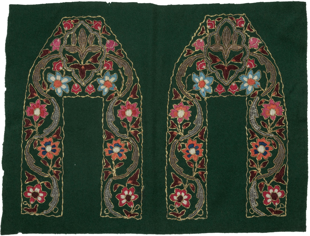 This vibrant green wool panel is richly adorned with colorful chain-stitch embroidery and was originally intended as the upper portions of traditional Kashmiri slippers (jooti or khussa). The bold floral motifs—rendered in vivid coral, blue, crimson, and ivory silk threads are enclosed within sweeping arabesques and stylized lotus forms, all outlined with gleaming metallic thread.
