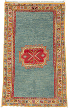 Handwoven by Amazigh weavers of the Aït Ouaouzguite tribe in Morocco’s High Atlas Mountains, this vintage rug reflects one of the region’s most celebrated weaving traditions. Distinguished by its fine weave, bold geometric design, and brilliant saffron yellow, a hallmark of Aït Ouaouzguite textiles, it embodies the vibrant artistry that has made these rugs among Morocco’s most sought-after weavings. The motifs are set against expansive fields of luminous ocean blue, whose generous negative space lends the c