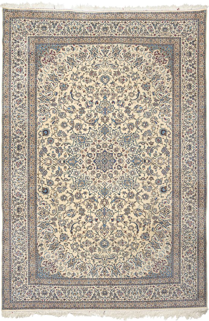 This elegant Nain rug reflects the refined aesthetic that has made these weavings among the most admired of the&nbsp;workshop&nbsp;carpet tradition. Woven on a luminous ivory field, the design centers on a delicate floral medallion surrounded by an exceptionally graceful network of scrolling arabesques, palmettes, and finely drawn flowering vines. A restrained palette of ivory, sapphire, powder blue, taupe, and soft celadon creates an atmosphere of quiet sophistication while allowing the intricate drawing t