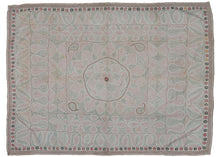 Antique large Kantha featuring a central floral sun-like mandala flanked by paisley or "Kalka" forms in each cornice. It has a limited palette of various red and black threads on a plain white cotton ground which is subtle but intriguing. Fine stitching and whimsical movement play well with the large scale and use of negative space. Perfectly framed by thin pinwheel and arrowhead borders. 