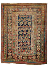 Antique Caucasian Chi Chi scatter rug featuring classic chi chi patterning of hooked polygons, rosettes, and alternating arrows in soft blues, yellows and reds on an inky blue field. The main border features characteristic bursting rosettes on a lovingly oxidized brown. An abrashed laleh abbassi gaurds the perimeter of the rug. 