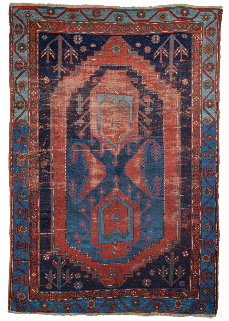 Antique Caucasian rug that features a figure 