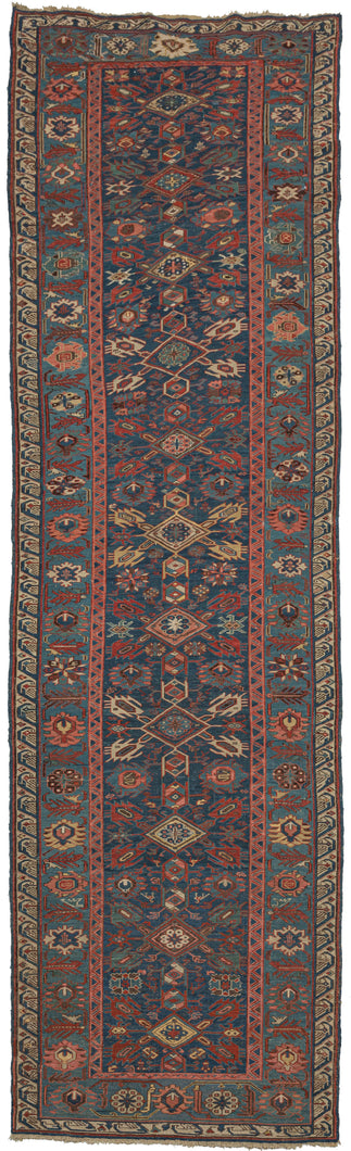 Antique Caucasian soumak runner featuring a repeat geometric pattern in rich jewel tones of reds, pinks, blues, greens, and yellow with accents of ivory and brown. Nicely framed by a wide main border of alternating palmettes and serrated leaves and finished with a minor 