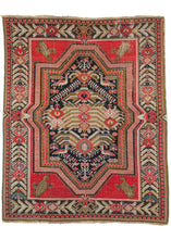 Antique Floral Karabagh scatter rug featuring a powerful medallion of angular leaves, rose-inspired palmettes, and a depiction of birds in red, pink, green, brown ivory, and gold on a black ground. Very baroque in feel the medallion crosses over in the border and is flanked by four cornices. Each cornice features a single leaf with a strong personality. The whole is framed by rows of angular leaves broken up by the same pairing of rose palmettes as the field.