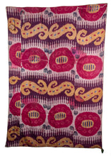 handwoven silk central asian Uzbeki Ikat Textile with bright pinks and yellows but also has fire damage and color run