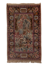 Small pictorial rug handwoven in India, featuring a variety of animals in a forest setting, and a rider on horseback. In excellent condition, signs of wear consistent with age. 