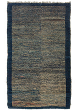This Blue Tibetan Mat features a striated field of various blues and ivory accentuated by tiny moments of pinks, oranges, and soft browns. The rug has two subtly distinctive halves but was woven on one loom and may have been created this way to purposely reference classic Tibetan Tsuk-Truk weavings. The otherwise random color usage creates a very organic and pleasing composition that is perfectly framed by a solid blue border. 