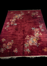 Burgundy Chinese Deco rug with multi colored flowers in balanced groupings
