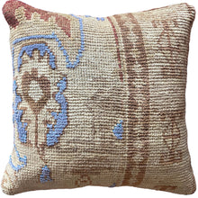 Pillow crafted from fragments of handwoven antique Oushak rug from Turkey.