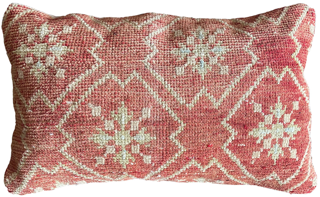 Pillow crafted from fragments of handwoven antique Oushak rug from Turkey.