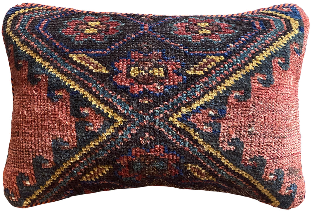 Pillow crafted from fragments of handwoven antique Kurdish rug 