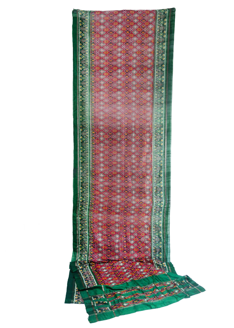 Silk Ikat woven Saree sari featuring patterning of diamonds, Xs, and rosettes in well contrasted red, green, yellow, purple, and white rendered in lustrous silk.