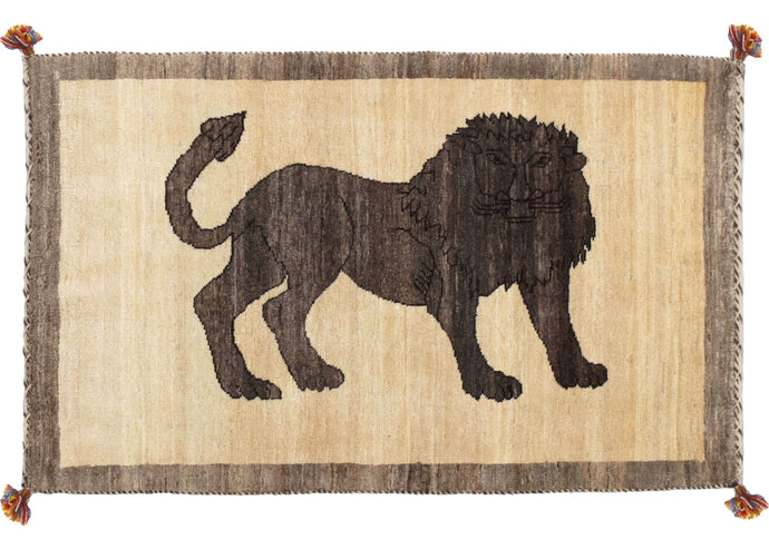South Persian Lori Lion Gabbeh featuring a deep grey lion on a variegated field of undyed wool. A wide soft gray border frames the field. The pile is lush and densely woven. 