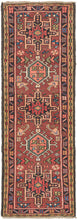 Vintage small Karaja runner featuring a pattern of alternating geometric shapes and hooked lozenges on a red ground. Blues, green, charcoal, gold, pink, and ivory provide a well-balanced palette. In a rare narrow and short runner format.