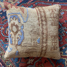 Pillow crafted from fragments of handwoven antique Oushak rug from Turkey.